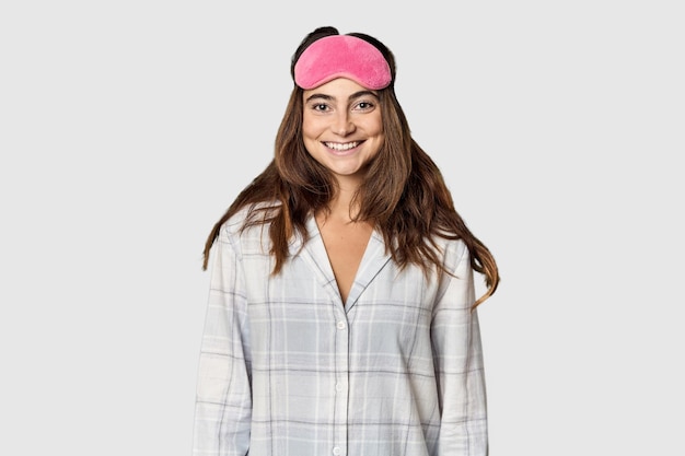 Sleepy Caucasian woman in pajamas with sleep mask