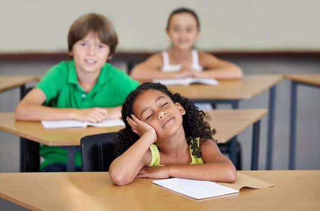 Photo sleepy children and bored of learning education or books from adhd burnout or frustrated with mindset in school exhausted girl or thinking of studying group or problem with fatigue in classroom