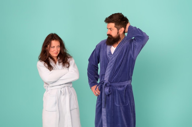 Sleepy people blue background. Couple in love bathrobes. Sleep disorders. Drowsy and weak in morning. Morning routine. Couple sleepy faces clothes for sleep. All day pajamas. Quarantine concept.