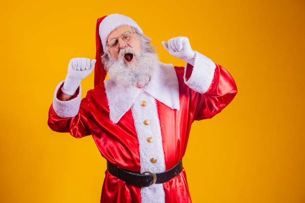 Sleepy Santa Claus with yellow background, wearing glasses and hat. Sleepy Santa Claus.