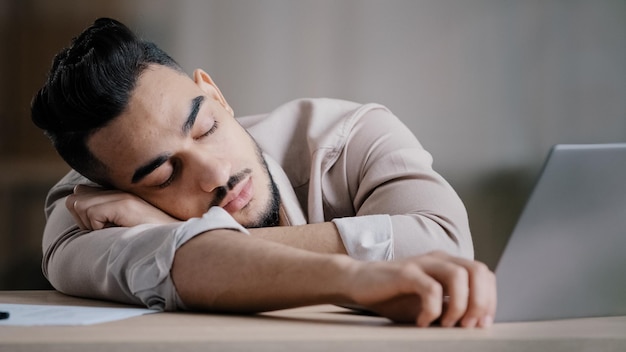 Sleepy unproductive man office male worker businessman falling asleep at office desk tired