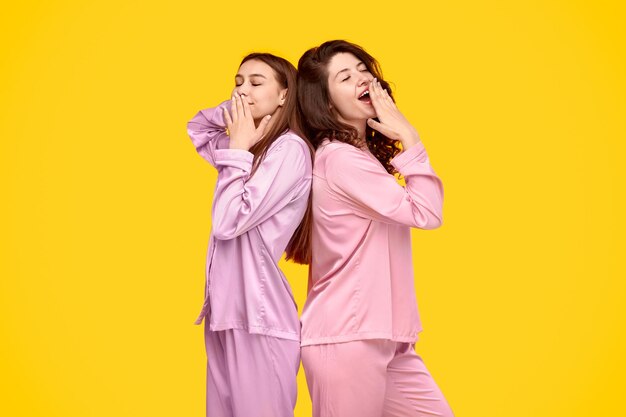 Sleepy and yawning women in pajama