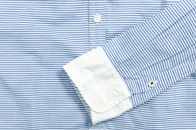 Sleeve of blue and white striped shirt. 