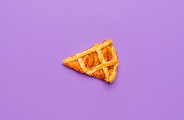 Slice of apricot pie on a purple background last piece of the pie