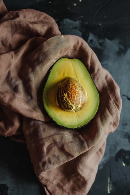 a slice of avocado on a brown cloth