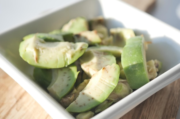 Slice of avocado on wooden table