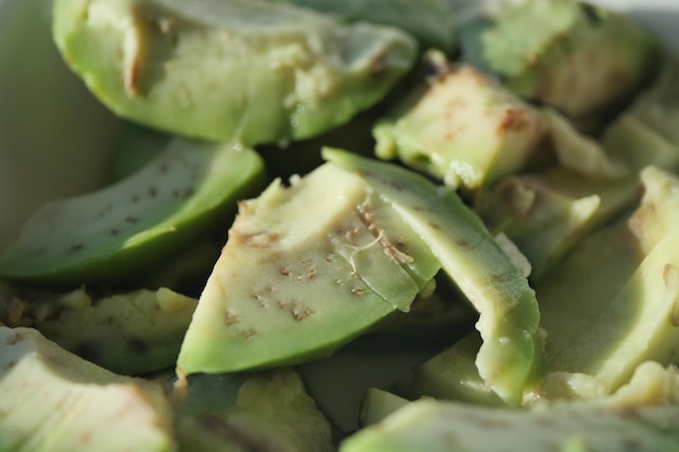 Slice of avocado on wooden table