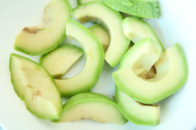 Slice of avocado on wooden table