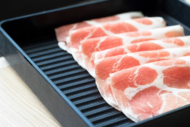 Slice bacon on grill