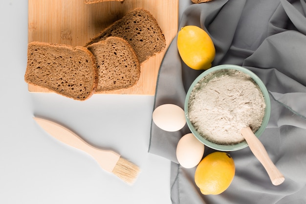 Slice of bread, flour and eggs on the table