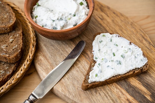 Slice of Bread with fresh made Herb Curd (detailed close-up shot)