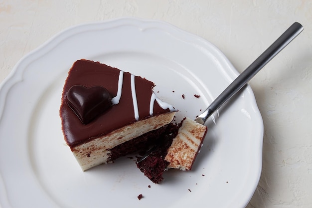 Slice of cake bird39s milk chocolate sponge cake with souffle sweet dessert on a white plate closeup horizontal no people