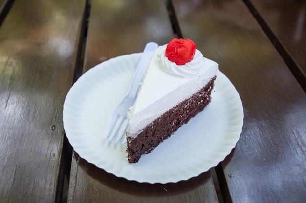 Slice cake on wood background