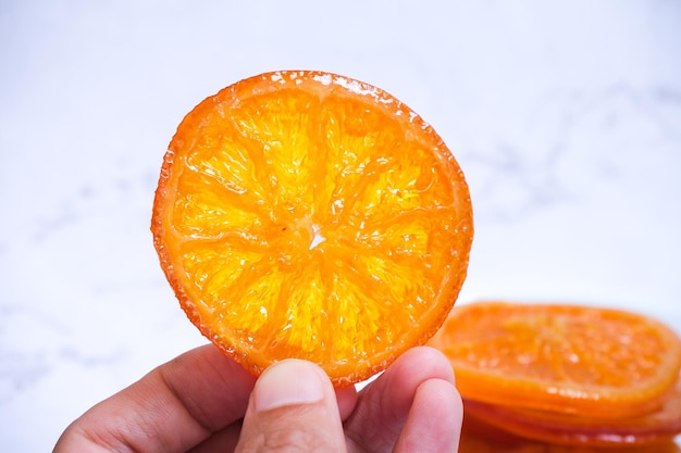 Slice of candied orange with white background