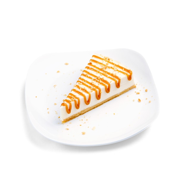 Slice of cheesecake with caramel and peanuts Dessert in a cafe Isolated object on a white background