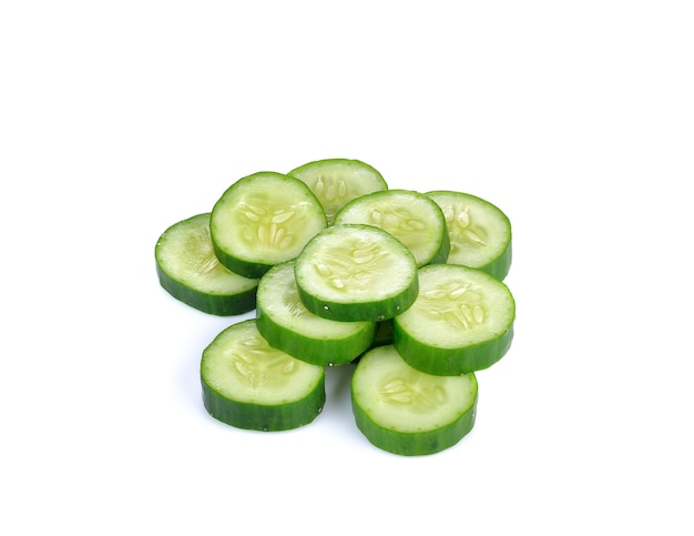 Slice of cucumber on white wall