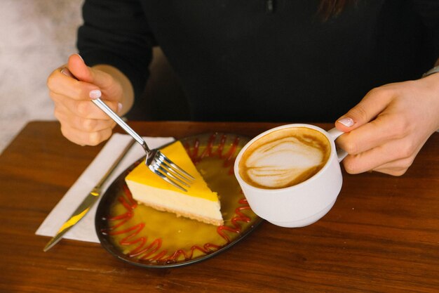 A slice of delicious cheesecake and a cup of coffee