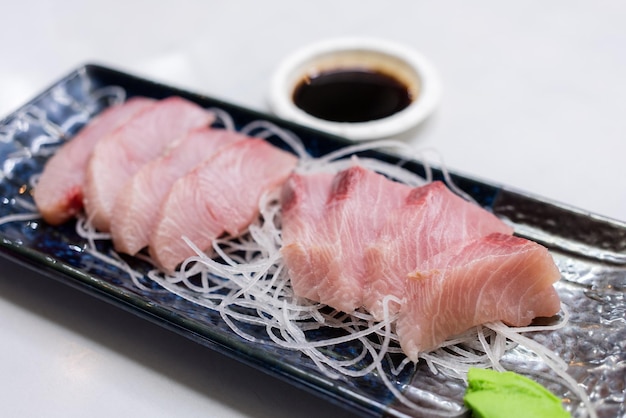 Slice of fish sashimi on plate