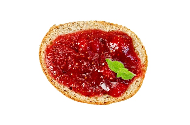 Slice of french bread with strawberry jam and mint isolated on white background with a view from above