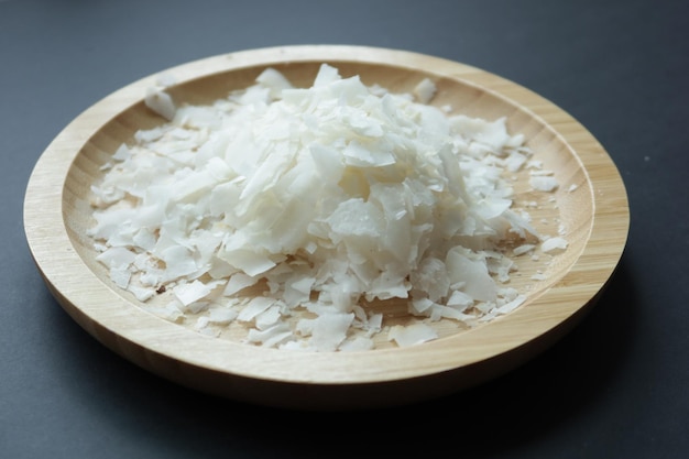 Slice of fresh coconut flakes in a bowl on a table