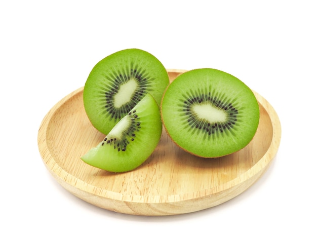 Slice of fresh and healthy kiwi fruit on wooden plate, isolated on white background.