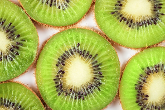 Slice of fresh kiwi fruit isolated on white background. top view.