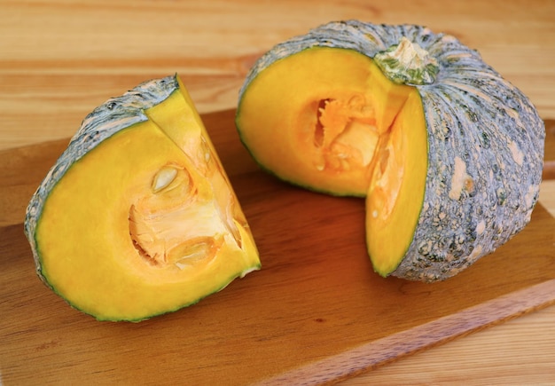 Slice of Fresh Pumpkin on Wooden Chopping Board