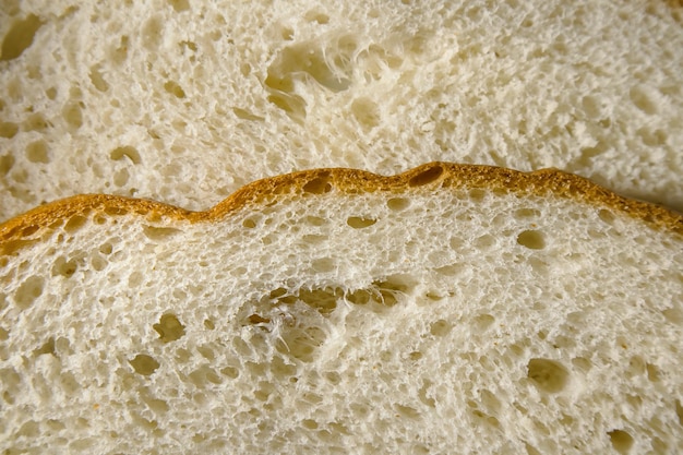 Slice of freshly baked wheat bread texture close up