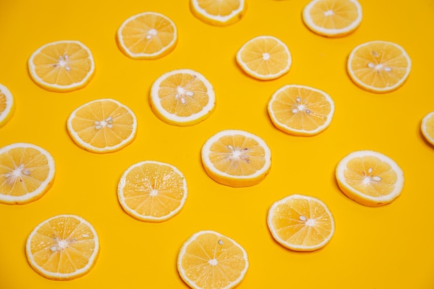 Slice of lemons on yellow background Cute wallpaper for summer healthy drink