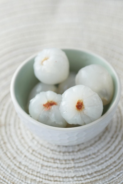 Slice of lychee in a bowl on table