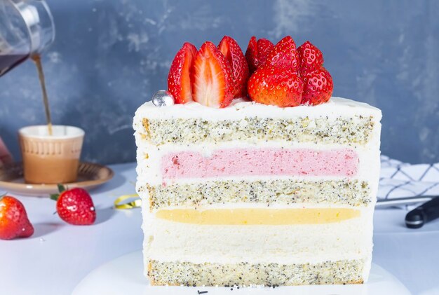 Slice of mouthwatering strawberry cake on gray concrete background Summer cake