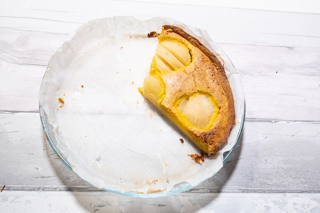 Slice of pear tart in its baking pan