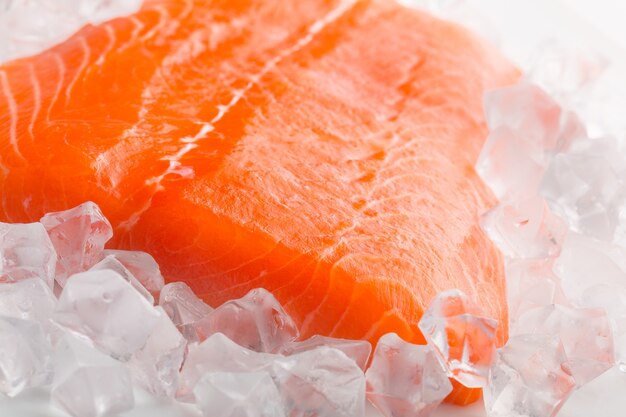 Slice of raw salmon in ice, close-up