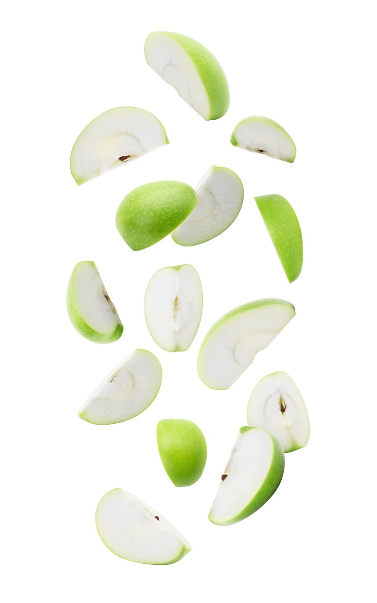 Photo slice ripe green apple falling isolated on white with clipping path.