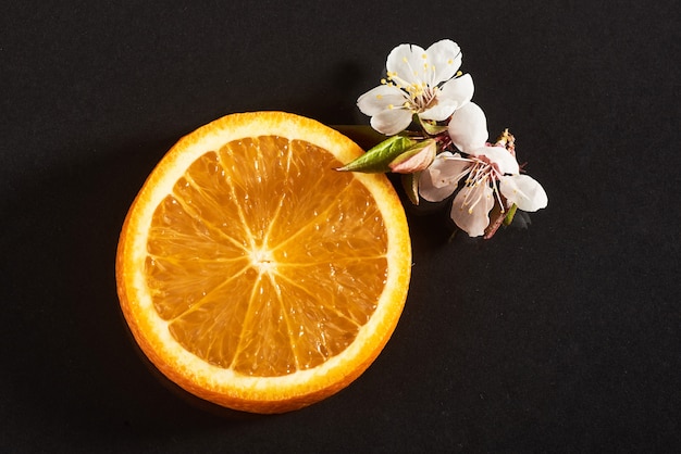 Slice ripe orange citrus fruit isolated on a black.