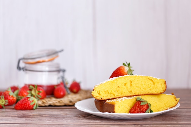 Slice of Shaker Lemon Pie onwhite plate with strawberries