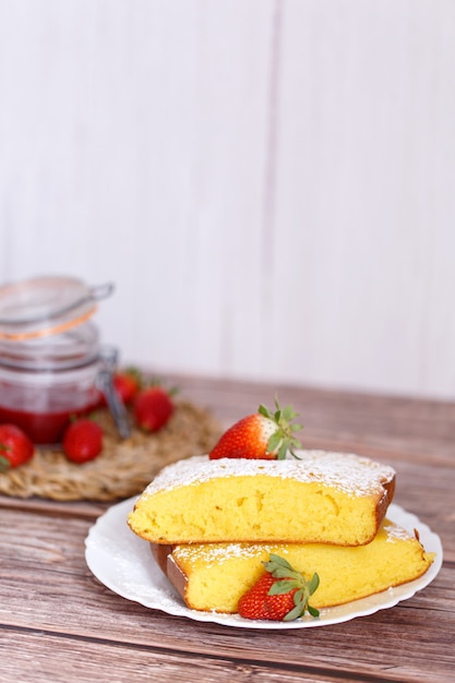 Slice of Shaker Lemon Pie onwhite plate with strawberries