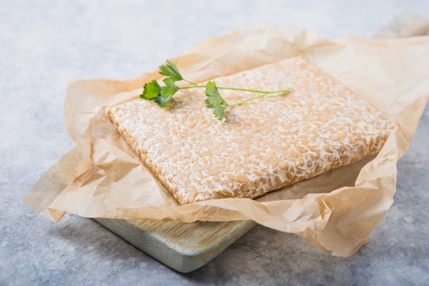 Slice of tempeh  or tempe made of fermentation process that binds soybeans, is traditional food from indonesia and malaysia