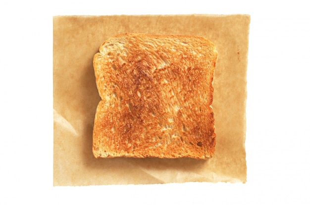 Slice of toasted bread on paper isolated