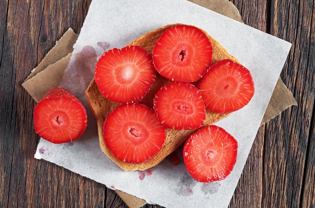 Slice of toasted bread with fresh strawberries