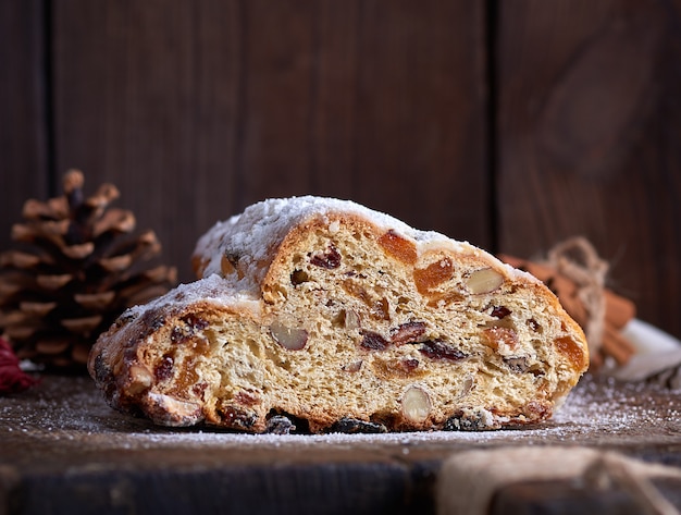 Slice traditional European cake Stollen with nuts and candied fruit 