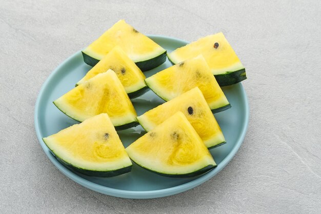 Slice yellow watermelon or semangka kuning  on grey background Selected focus