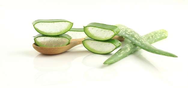 Sliced aloe vera on spoon herbal medicine for skin and hair on white