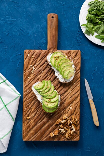 Sliced avocado on toast bread with nuts breakfast and healthy food concept