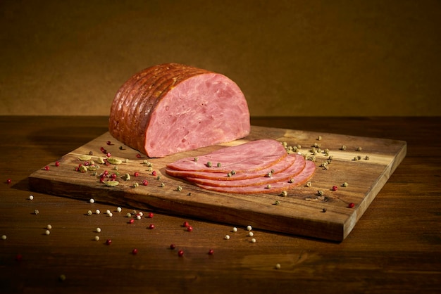 Sliced bacon with pepper on a wooden surface