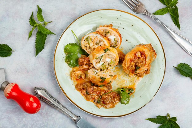 Sliced baked clams squid stuffed with rice and nettle on a light grey background Korea food