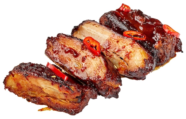 Sliced baked pork ribs in barbecue sauce with chili pepper isolated on white