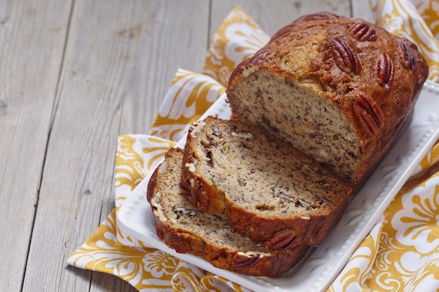 Sliced banana bread with a pecan nuts