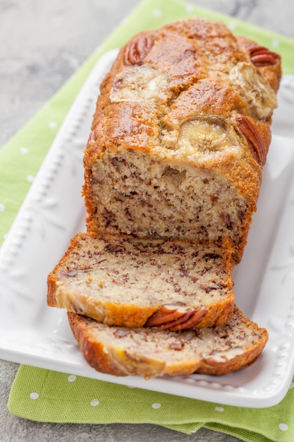 Sliced banana bread with a pecan nuts