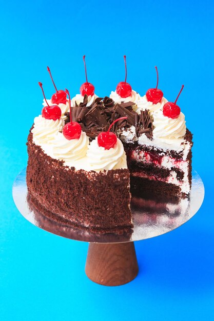 Sliced Birthday cake on the wooden cake stand